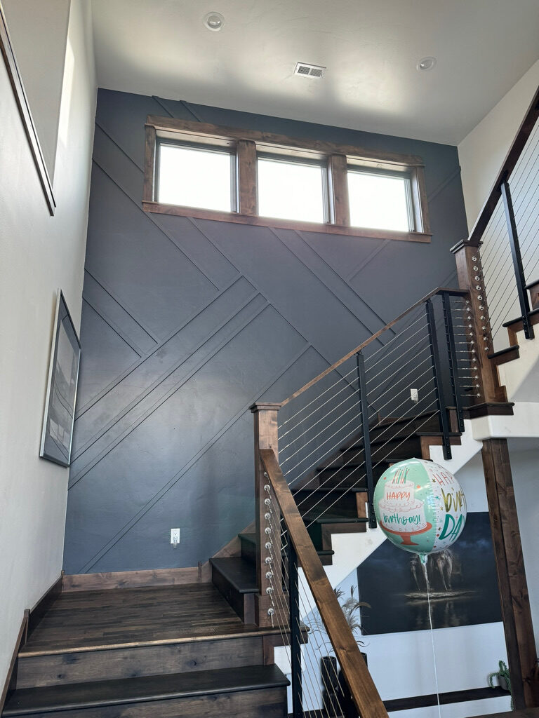 Custom staircase with wood rail and cable balusters