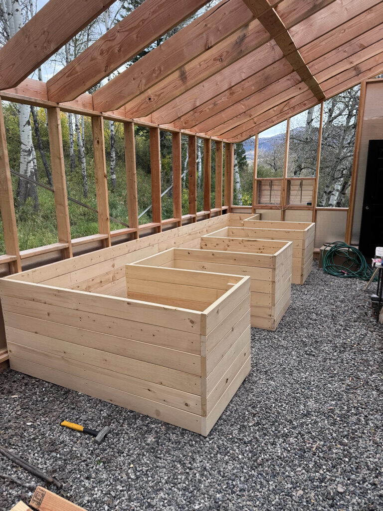 Raised garden beds beneath a timber structure